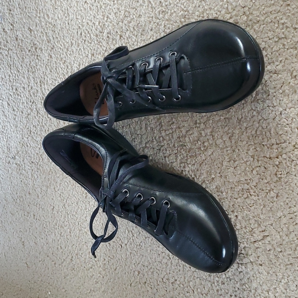 Clarks black leather lace up flats, size 11M